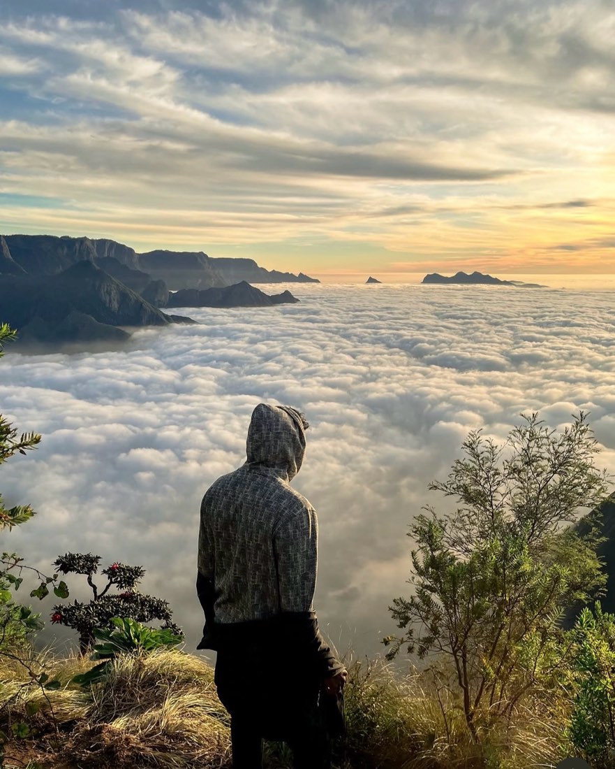 A trekker over a sea of cloud at first light